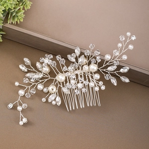 Detail of handcrafted bridal hair comb with silver wire, white pearls and clear crystals