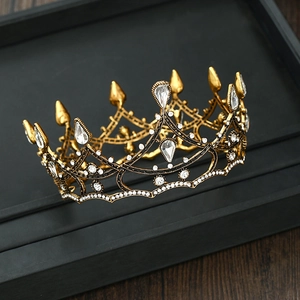 Macro shot of gold baroque bridal crown with white crystals and teardrop gems