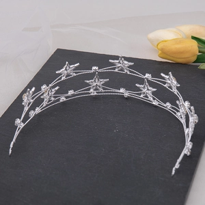 Close-up of silver bridal headband featuring crystal stars and layered metal wires