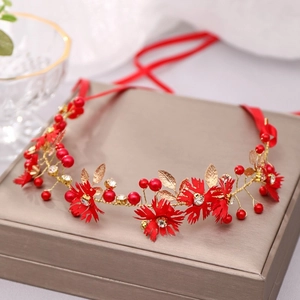 Handmade red flower bridal headband with gold leaves and rhinestones on a display box