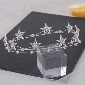 Detailed view of silver bridal headband with crystal stars on black stone and tulle