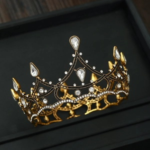 Close-up of vintage Baroque bridal crown with gold filigree and teardrop crystals