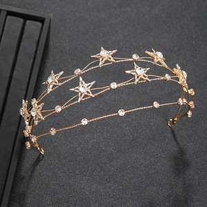 Macro view of gold bridal headband with multi-layer stars and sparkling crystals