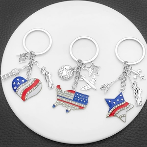 USA flag themed keychain set with heart and map charms on a white display tray