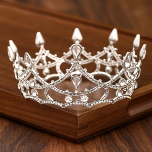 Detail of silver vintage baroque bridal crown with sparkling crystal rhinestones on wood
