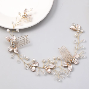 Elegante pettine da sposa dorato con perle e cristalli su un piatto di ceramica bianca