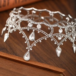 Detailed macro view of vintage silver bridal tiara with crystals and teardrop pendants