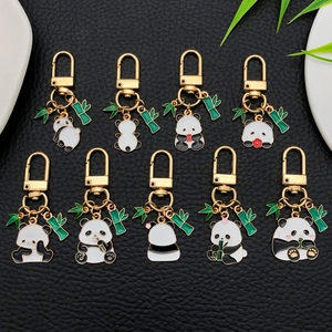 Cartoon panda keychain set with bamboo leaf charms and golden metal U-shaped hooks
