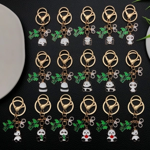 Cartoon panda keychain set with green bamboo charms and golden lobster clasp on black leather