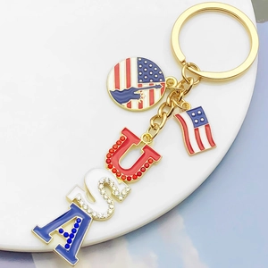 Close-up of USA letter pendant with American flag and Statue of Liberty keychain charm