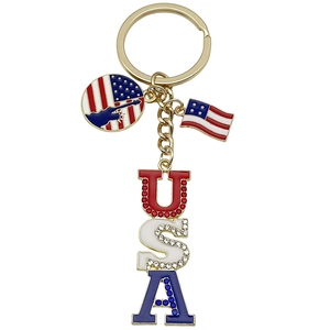 Golden American flag keychain with USA letters and patriotic silhouette on white background
