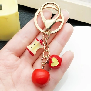 Cute red resin apple keychain with core charms on a gold ring for bags and keys