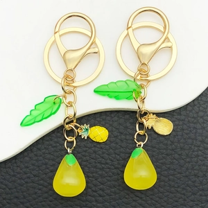 3D resin fruit keychains featuring pineapple and pomelo with gold lobster clasps and green leaves