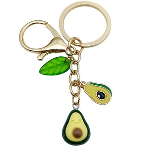 Cute green avocado keychain with gold metal clasp and smiling fruit pendant charms