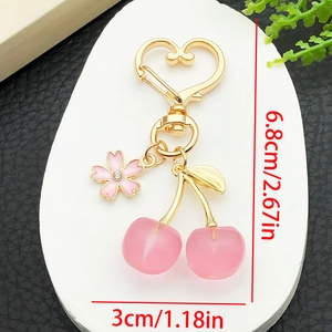 Detail view of pink cherry keychain with gold frame showing size 6.8cm by 3cm