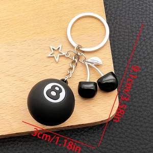 Close-up of Billiard 8-Ball and cherry keychain on wood tray with size measurements