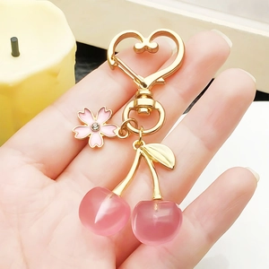 Pink cherry and sakura keychain with heart ring and golden leaf for bags and backpacks