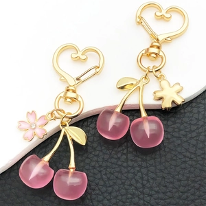 Pink resin cherry keychain with gold heart clasp and enamel flower charm for bags
