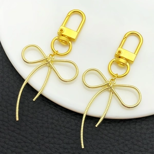 Elegante coppia di portachiavi a fiocco in metallo dorato per borse con ganci a forma di U