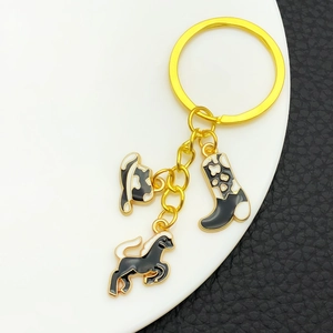 Golden Western cowboy keychain with enamel hat, cow print boot and horse charms