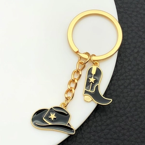 Vintage cowboy hat and boot keychain with golden star on black enamel finish