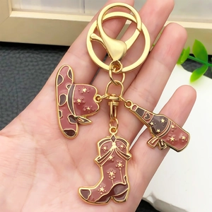 Golden keychain with western style brown enamel cowboy hat, boot, and wine bottle charms