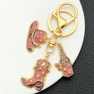 Western cowboy keychain set with red enamel star hat, boot and wine bottle charms