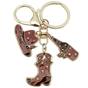 Western cowboy style keychain with brown enamel hat, boot and bottle charms on gold metal