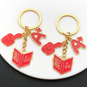 Enamel red A+ thumb and magic book keychain set with gold finish for graduation gifts