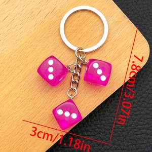 Detailed view of translucent purple resin dice keychain with silver chain and size markings