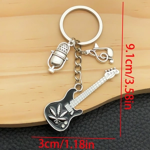 Rock music keychain with black guitar, microphone charm, and musical note on wood background