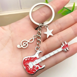 Handheld rock music keychain with red flame guitar, treble clef, and star pendant charm