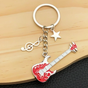 Guitar keychain with red flame pattern and musical note charms on a textured background