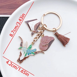 Detail showing dimensions of the Western cow skull and cowboy hat tassel keychain