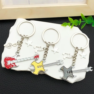 Electric guitar keychains with star and note charms in red, yellow, and black colors