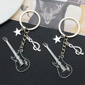 Close-up of black guitar and music note charms on a high-quality metal keychain
