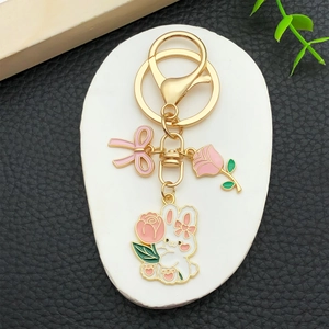 Chinese style cartoon rabbit keychain with pink bow and rose on an elegant black background