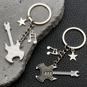 Detailed macro view of rock guitar keychains with engraved patterns and star musical charms