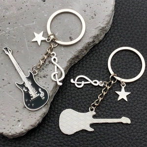 Detail of guitar keychain with black enamel finish and diamond textured back