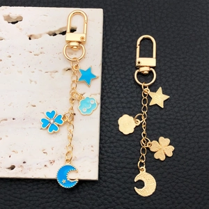 Golden alloy U-buckle keychain with blue enamel star, moon and four-leaf clover charms