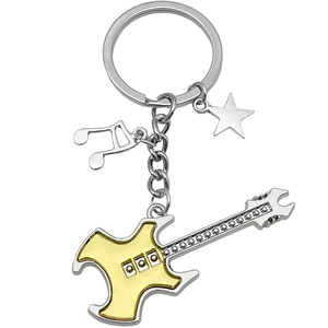Golden guitar keychain with silver music note and star charms on polished metal ring