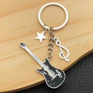 Music themed keychain featuring black electric guitar star and treble clef pendants