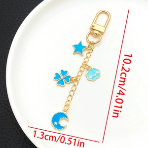 Detail view showing blue enamel charms on a gold keychain with dimensions 10.2cm length