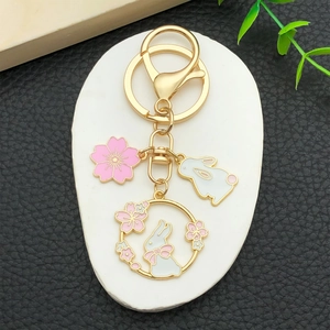 Cartoon rabbit and cherry blossom gold metal keychain with pink enamel flower charms