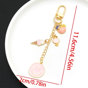 Détail du porte-clés doré avec breloques émaillées rose glace et sourire avec dimensions