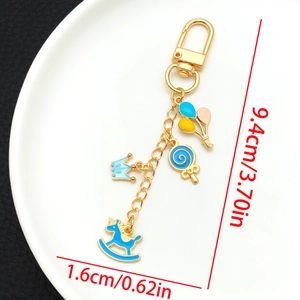 Detail view of the colorful enamel charms and spring buckle on a gold-plated keychain