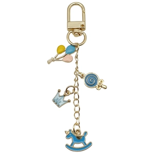 Golden alloy U-shaped keychain with blue enamel rocking horse and crown charms