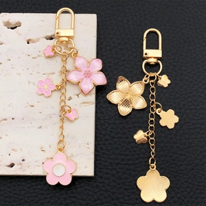 Pink sakura flower and butterfly U-shaped keychain set with golden enamel finish
