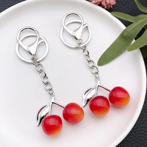 Creative resin cherry keychain with red gradient fruit charms and silver leaf details