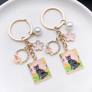 Japanese style black cat and cherry blossom keychain with gold enamel finish